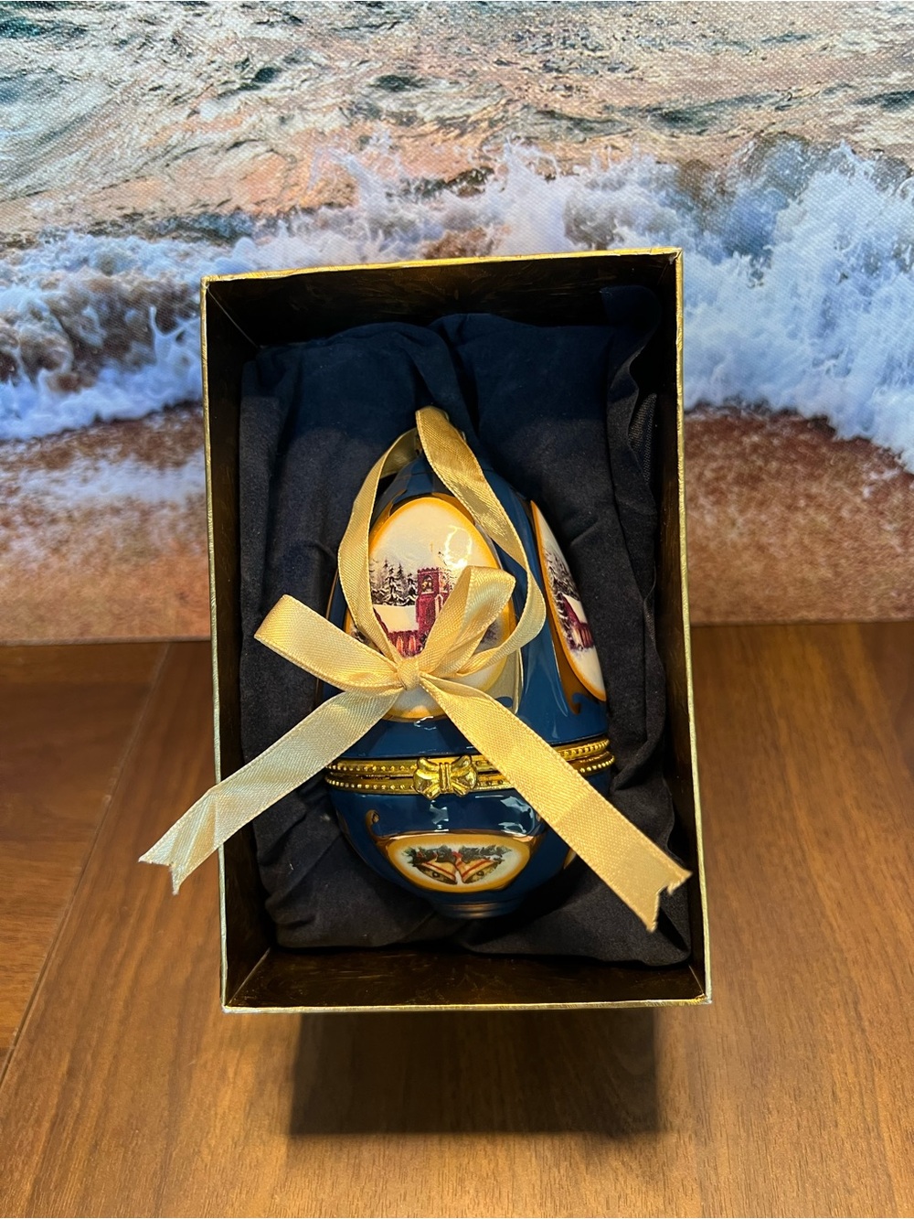 Blue Porcelain Decorative Egg Trinket Box with Gold Ribbon Accent.